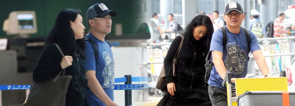 那英一身黑衣现身机场 老公低调推行李