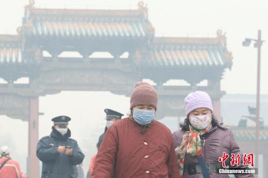 11月8日，沈阳遭遇雾霾天气，pm2.5值爆表。图为沈阳故宫门前市民戴口罩出行。 图片来源：视觉中国