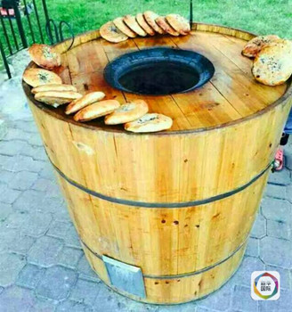 　　图为多伦多华侨制作缙云烧饼的木桶炭炉