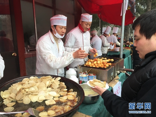 2月11日,游客在厂甸庙会上品尝京味儿小吃。 新华网记者 白羽 摄