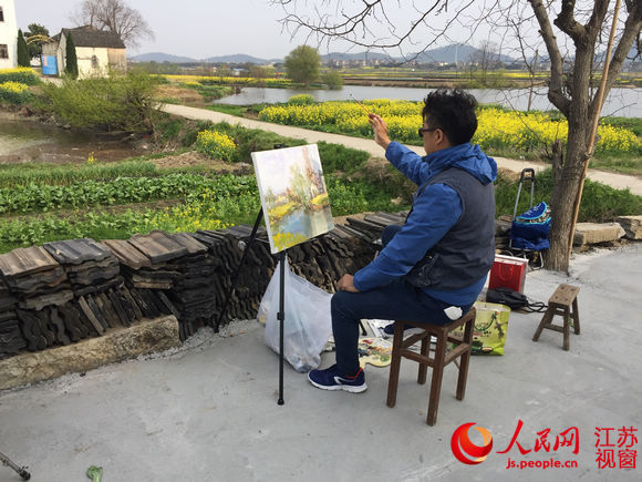 江苏省美协会员、南京市美协会员王柏夫在油菜花田边写生