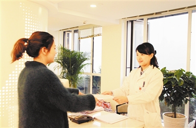 工作人员为市民送上体检报告。