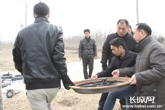 自来水公司为东县南村拉来通水管道，李清榜高兴地帮着搬这搬那。长城网 贺宏伟 摄