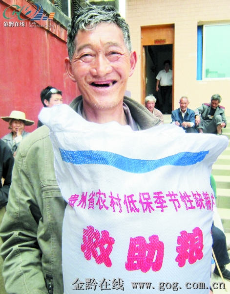 领到季节性粮食救助的农村低保老人.