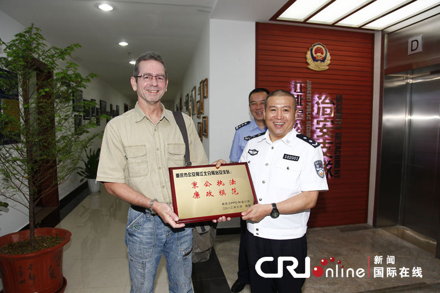 2012年6月5日，重庆市，梅生将牌匾送到江北分局局长王志勇手上。 图片来源：cfp