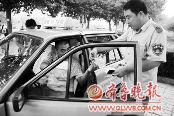 　　20日,检查人员上路检查出租车证件是否齐全。　　本报记者　王鸿光　摄