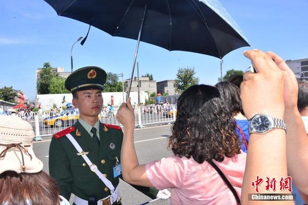 这两位来自浙江的大姐为中国武警战士撑伞纳凉