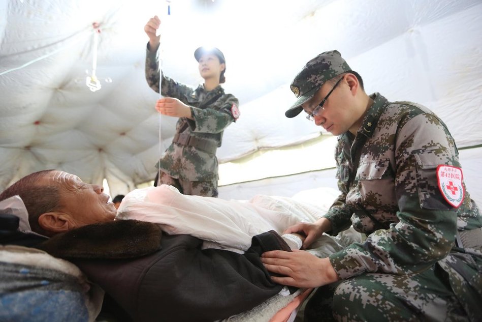 解放军42医院医生苏加庆(右)同妻子杜丹和为芦山地震受伤老人杨显忠